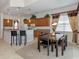 Open concept kitchen features granite counters and breakfast bar at 117 Savona Way, North Venice, FL 34275
