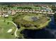 Aerial view of a peaceful lake and golf course at 117 Savona Way, North Venice, FL 34275