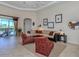 Bright living room with view of pool and access to the backyard at 117 Savona Way, North Venice, FL 34275