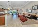 Open floor plan with living room, kitchen, breakfast bar, and views of the pool at 117 Savona Way, North Venice, FL 34275