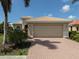 House exterior featuring a two-car garage at 117 Savona Way, North Venice, FL 34275