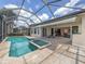 Screened pool and spa with extended patio and view to the interior at 117 Savona Way, North Venice, FL 34275