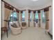 Bright bedroom with window seating and pool view at 117 Savona Way, North Venice, FL 34275