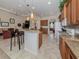 Open kitchen with granite counters and breakfast bar seating at 117 Savona Way, North Venice, FL 34275
