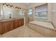 Bathroom boasts a large soaking tub, walk-in shower, and double vanity at 145 Montelluna Dr, North Venice, FL 34275