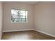 Empty bedroom with large window and wood-look flooring at 145 Montelluna Dr, North Venice, FL 34275