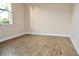 Simple bedroom with window and wood-look flooring at 145 Montelluna Dr, North Venice, FL 34275
