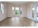 Bright Gathering room featuring wood-look flooring, multiple windows, and sliding glass doors at 145 Montelluna Dr, North Venice, FL 34275