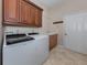 Laundry room with washer, dryer, cabinets, and additional storage at 145 Montelluna Dr, North Venice, FL 34275
