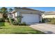 Charming home features a well-manicured lawn and a two-car garage with clean white doors at 1586 Monarch Dr # 1586, Venice, FL 34293