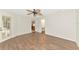 Bright bedroom featuring wood floors, a ceiling fan, and a view into the kitchen at 1929 Tradewinds Cir, Venice, FL 34293