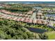Beautiful aerial view of the home, surrounded by lush landscaping and tranquil waters, golf course, and other homes at 277 Mestre Pl, North Venice, FL 34275