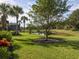 Beautiful backyard features lush lawn and a tranquil pond view at 277 Mestre Pl, North Venice, FL 34275