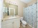 Standard bathroom with a vanity sink and a shower with a blue and white patterned shower curtain at 277 Mestre Pl, North Venice, FL 34275