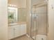 Bathroom featuring a glass-door shower and a vanity sink with a large mirror at 277 Mestre Pl, North Venice, FL 34275