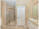 Bathroom featuring a glass-door shower and a vanity sink with a door to the hallway at 277 Mestre Pl, North Venice, FL 34275
