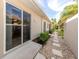 Exterior side view showing a walkway, landscaping, and access to the home's interior at 277 Mestre Pl, North Venice, FL 34275