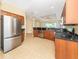 Bright kitchen featuring a stainless steel refrigerator, tile floors, and lots of cabinet space at 277 Mestre Pl, North Venice, FL 34275