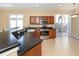 The kitchen features stainless appliances, dark countertops, and wood cabinetry at 277 Mestre Pl, North Venice, FL 34275