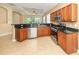 Open kitchen featuring stainless steel appliances, granite countertops, and tile flooring at 277 Mestre Pl, North Venice, FL 34275