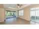 Spacious living room boasts tile floors and sliding door access to the screened-in lanai at 277 Mestre Pl, North Venice, FL 34275