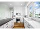 White kitchen with marble countertops and stainless steel appliances at 6415 Manasota Key Rds, Englewood, FL 34223