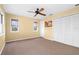 Light and airy bedroom with carpet floors, ceiling fan, and white closet doors at 6415 Manasota Key Rds, Englewood, FL 34223