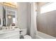 Stylish bathroom featuring modern fixtures, elegant mirror, and a shower-tub combination for a spa-like experience at 8209 Redonda Loop, Lakewood Ranch, FL 34202