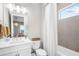 Bright bathroom with modern lighting, elegant vanity, and a shower-tub combination for a functional and stylish space at 8209 Redonda Loop, Lakewood Ranch, FL 34202