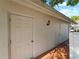 White storage units with double doors and exterior light at 760 Village Cir # 212, Venice, FL 34292