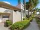Condo building with walkway, landscaping, and palm trees at 760 Village Cir # 212, Venice, FL 34292