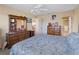 Main bedroom with dresser, large bed and ensuite bathroom at 760 Village Cir # 212, Venice, FL 34292