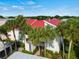 Condo building with red tile roof and palm trees at 760 Village Cir # 212, Venice, FL 34292