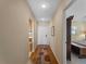 Hallway with wood flooring, leading to rooms and a laundry area at 760 Village Cir # 212, Venice, FL 34292