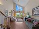 Spacious living room with vaulted ceilings and large windows offering abundant natural light at 760 Village Cir # 212, Venice, FL 34292