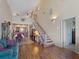 Living room with hardwood floors, staircase, and view into the dining area at 760 Village Cir # 212, Venice, FL 34292
