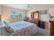 Bedroom with queen bed, dresser, and window with blinds at 760 Village Cir # 212, Venice, FL 34292