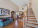 Living area with hardwood floors, staircase, and view into the dining area at 760 Village Cir # 212, Venice, FL 34292
