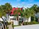 Condo building with red tile roof and lush landscaping at 760 Village Cir # 212, Venice, FL 34292