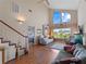 Open living area with high ceilings, hardwood floors, and view of the Primary bedroom at 760 Village Cir # 212, Venice, FL 34292