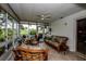 Bright sunroom with wicker furniture, a dining table, and golf course views at 214 Wexford Pl # 150, Venice, FL 34293