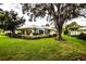 Single-story home with a well-manicured lawn at 214 Wexford Pl # 150, Venice, FL 34293