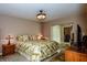 Main bedroom with king-size bed, two nightstands, and a flat-screen TV at 214 Wexford Pl # 150, Venice, FL 34293