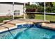 Enjoy this relaxing pool spa with tiled accents and water features at 856 Morgan Towne Pl, Venice, FL 34292