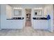 Double vanity bathroom with granite countertops and ample storage at 856 Morgan Towne Pl, Venice, FL 34292