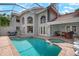 Inviting screened-in pool and spa area with brick pavers at 404 Cardiff Rd, Venice, FL 34293