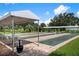 Community bocce ball courts with covered seating areas at 404 Cardiff Rd, Venice, FL 34293