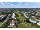 Aerial view showcasing a home situated on a golf course at 404 Cardiff Rd, Venice, FL 34293