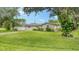 Single-story home nestled on a large lot with mature landscaping at 1560 Poinciana Rd, Venice, FL 34293