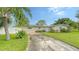 Charming single story home with a well-maintained front yard and driveway at 1560 Poinciana Rd, Venice, FL 34293